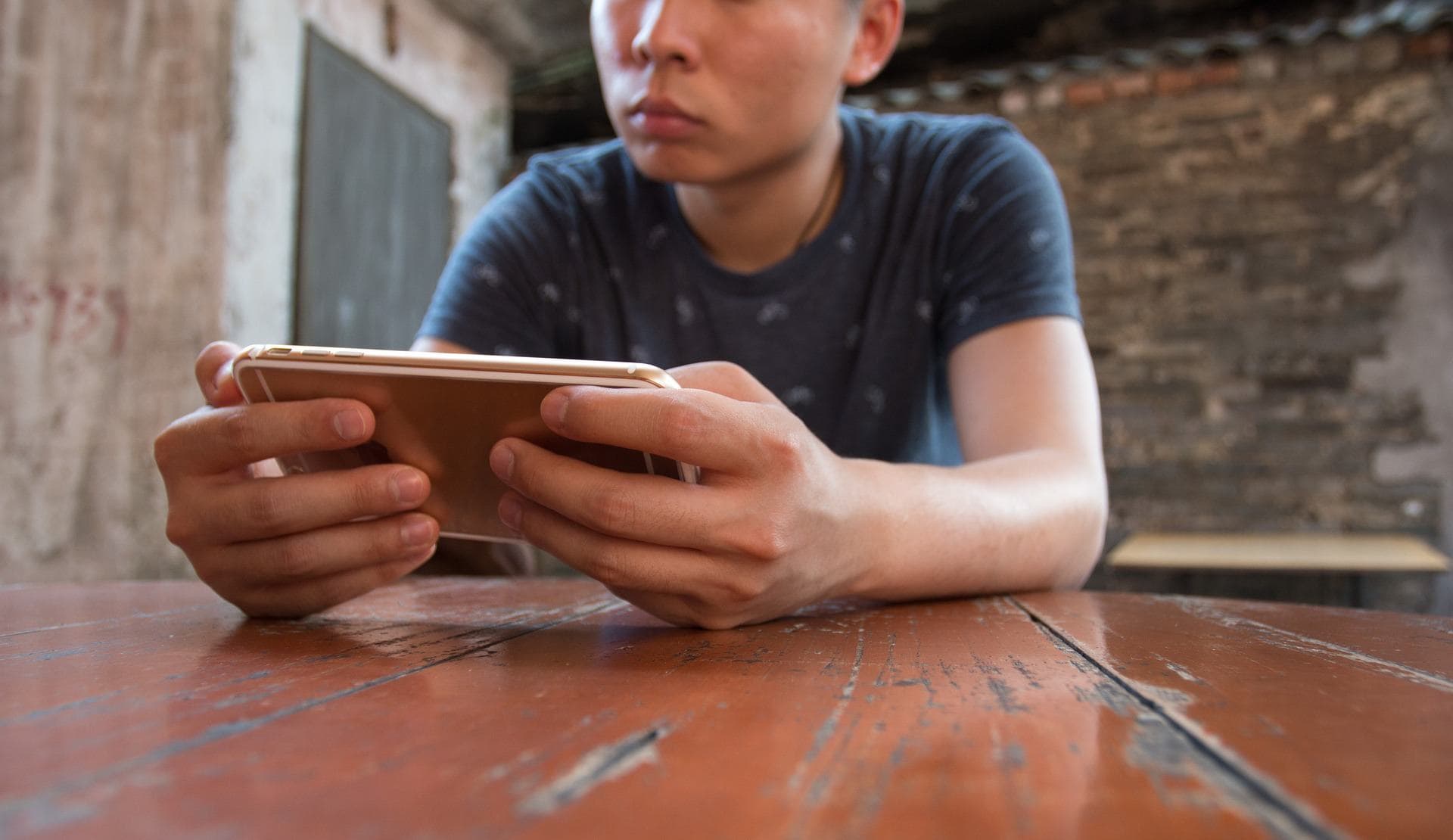 Young man on smartphone at table